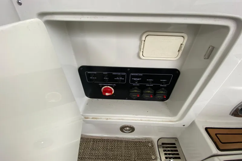 Slide: The Image of 2015 Crownline 335 SS boat interior with beige and white seating. - 15