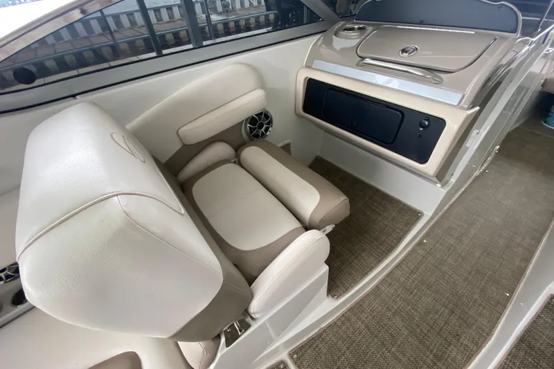 Slide: The Image of Storage compartment in 2015 Crownline 335 SS boat, featuring a concealed toilet. - 18