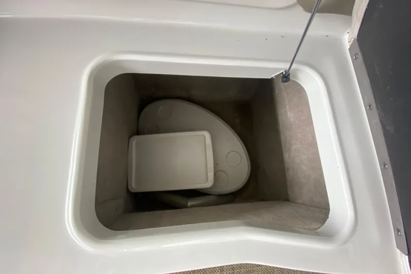 Slide: The Image of Storage compartment on a 2015 Crownline 335 SS boat, featuring a sleek interior design. - 19