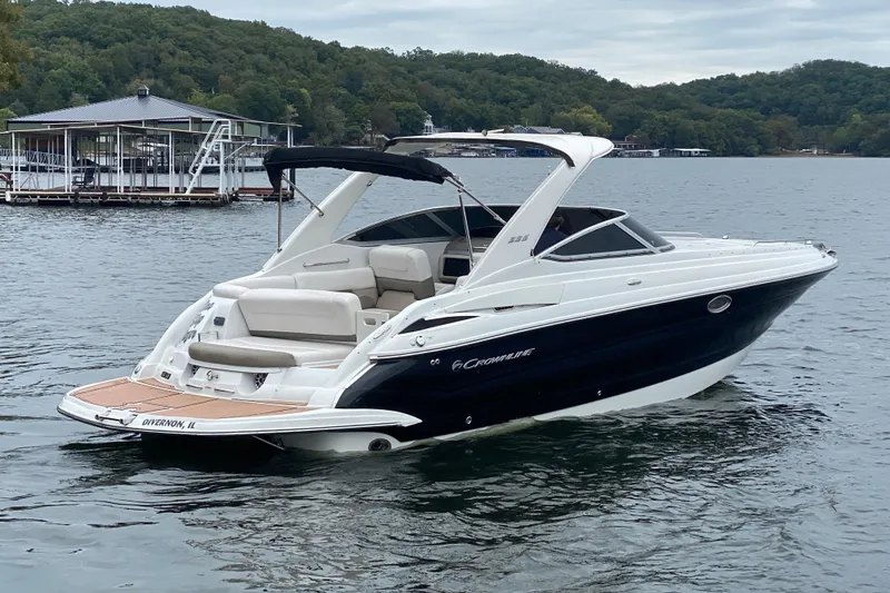 Slide: The Image of 2015 Crownline 335 SS boat on a lake with scenic background. - 2
