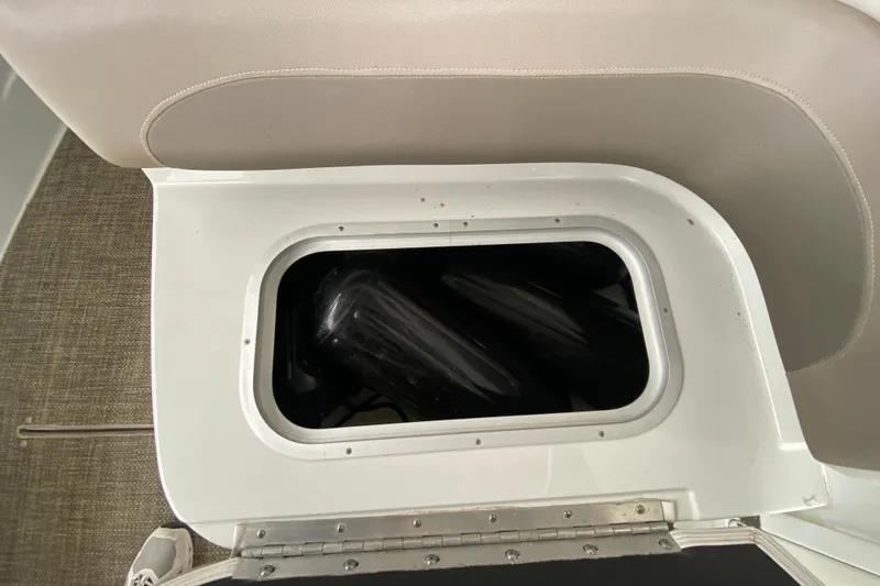 Slide: The Image of 2015 Crownline 335 SS boat interior with seating and storage compartments. - 20