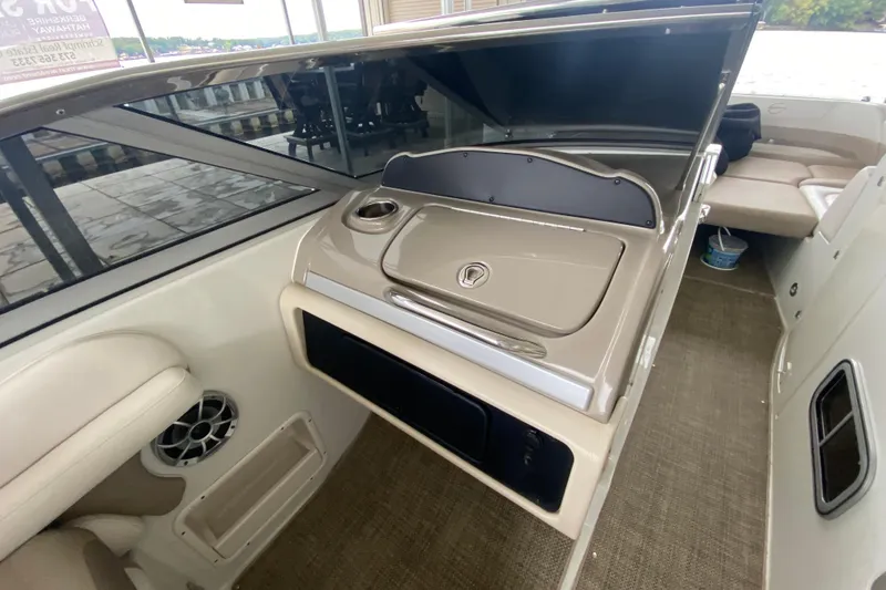 Slide: The Image of Storage compartment in 2015 Crownline 335 SS boat with coiled black rope. - 21
