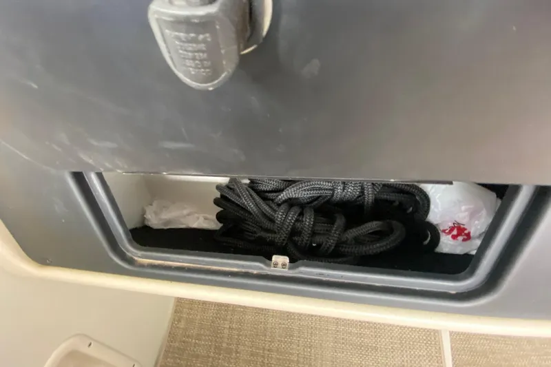 Slide: The Image of 2015 Crownline 335 SS boat interior with beige seating and speaker. - 22