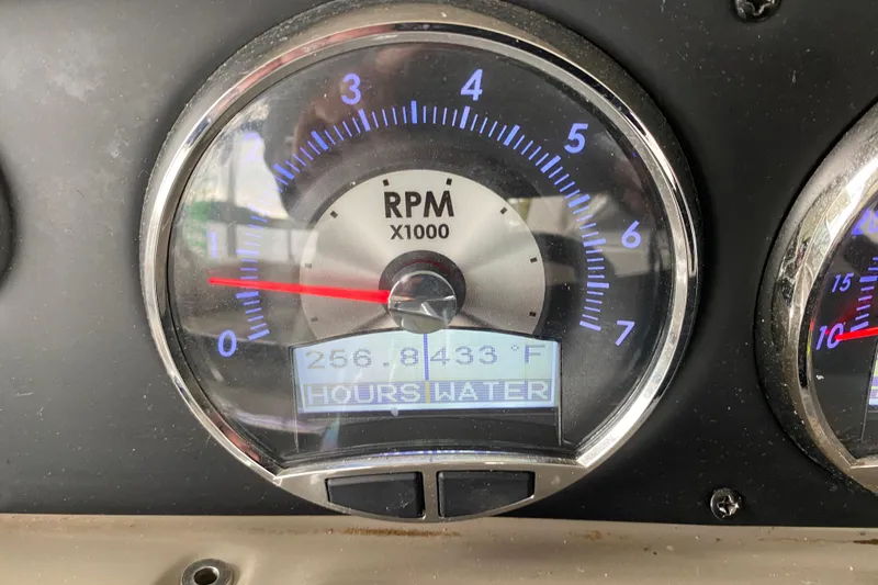 Slide: The Image of Close-up of 2015 Crownline 335 SS boat tachometer showing RPM and oil pressure. - 26