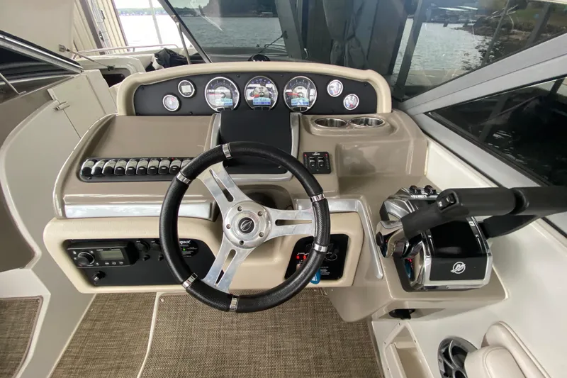 Slide: The Image of Control panel of a 2015 Crownline 335 SS boat with audio system and switches. - 28