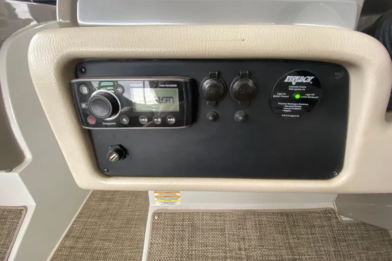 Slide: The Image of 2015 Crownline 335 SS boat interior with beige seating and steering wheel. - 29