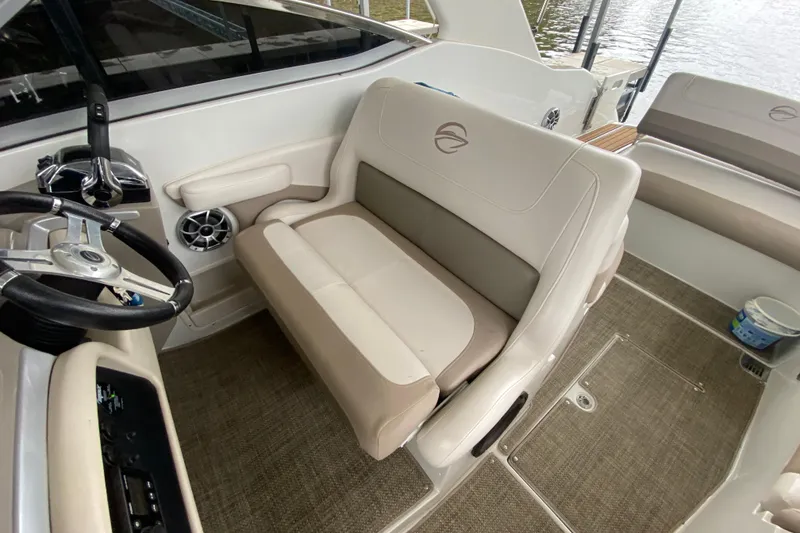 Slide: The Image of Interior of 2015 Crownline 335 SS boat with steering wheel and seating area. - 30