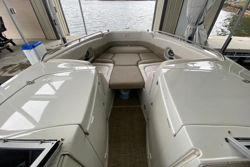 Slide: The Image of 2015 Crownline 335 SS boat interior with beige and white seating. - 32