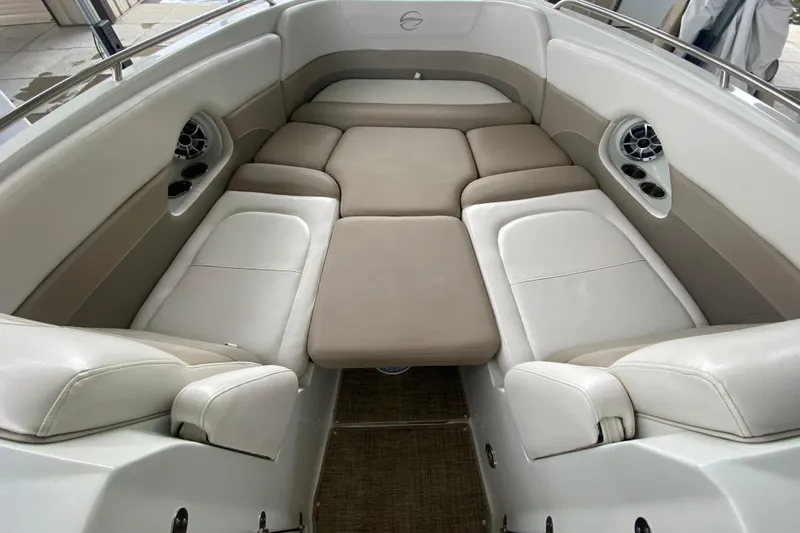 Slide: The Image of 2015 Crownline 335 SS boat interior with beige seating and carpeted floor. - 33