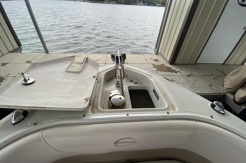 Slide: The Image of 2015 Crownline 335 SS boat bathroom with sink, toilet, and storage area. - 39