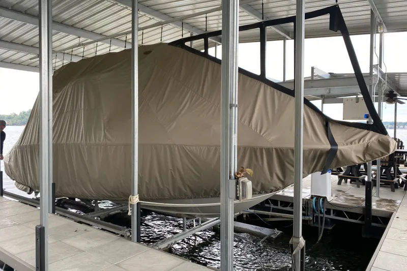 Slide: The Image of 2015 Crownline 335 SS boat docked under a covered marina. - 6