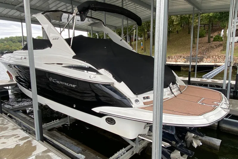 Slide: The Image of 2015 Crownline 335 SS boat with dual MerCruiser outboard engines in dock. - 9
