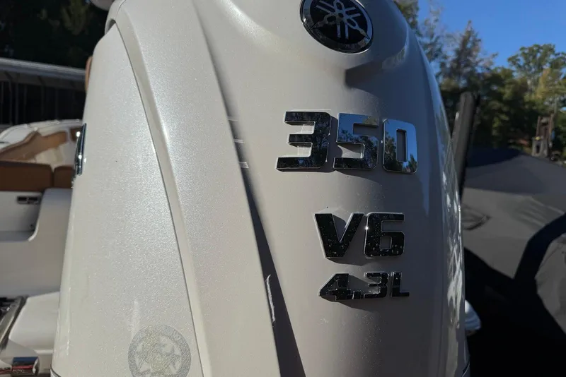 Slide: The Image of 2026 Key West 239 FSR boat with tan cushioned seating and integrated speakers. - 4