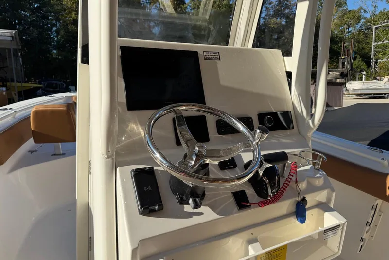 Slide: The Image of 2026 Key West 239 FSR boat console with steering wheel and navigation display. - 6