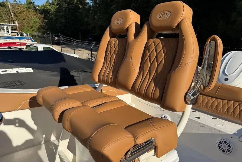 Slide: The Image of 2026 Key West 239 FSR boat interior with tan cushioned seating and sleek design. - 8