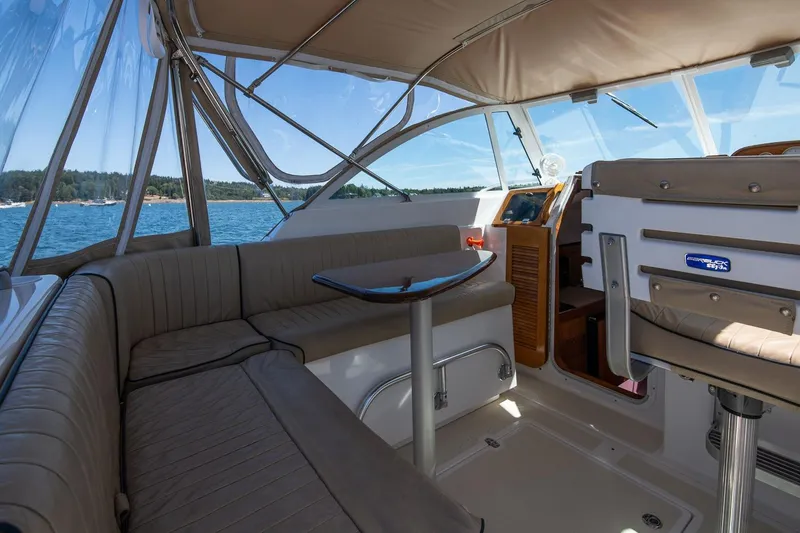 Slide: The Image of 2005 Hunt Yachts Surfhunter 29 interior with seating and table, overlooking scenic water view. - 11