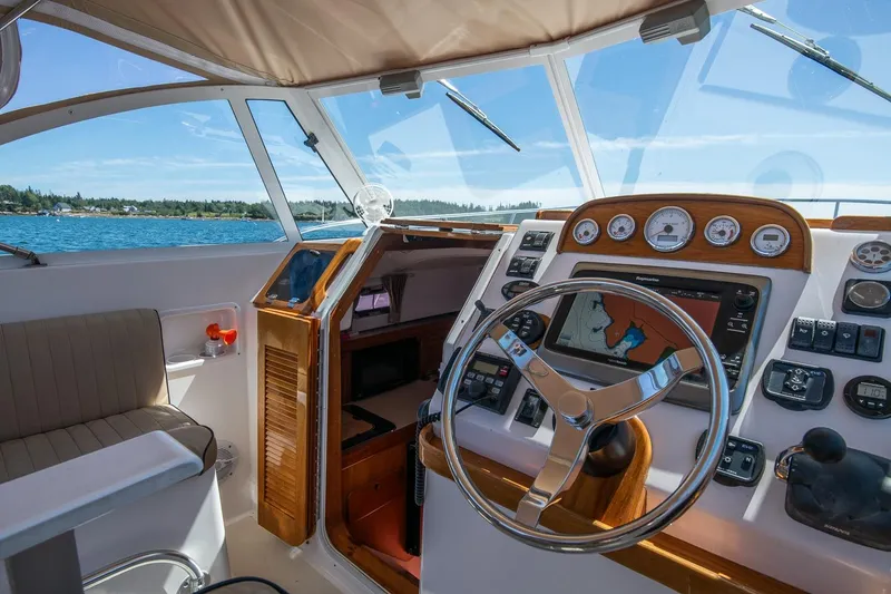 Slide: The Image of 2005 Hunt Yachts Surfhunter 29 helm with navigation system, steering wheel, and ocean view. - 14