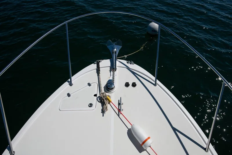 Slide: The Image of Bow of 2005 Hunt Yachts Surfhunter 29 on water, featuring anchor and railings. - 16