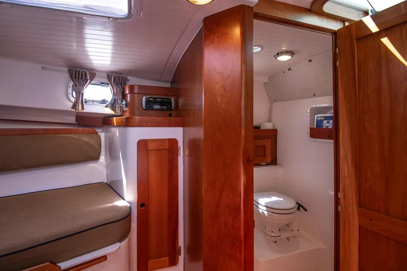 Slide: The Image of Interior of 2005 Hunt Yachts Surfhunter 29, featuring cozy cabin and compact bathroom. - 19