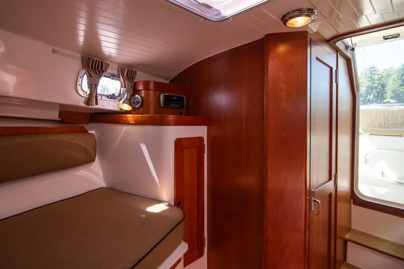 Slide: The Image of 2005 Hunt Yachts Surfhunter 29 cabin interior with wood finish and cozy seating. - 21