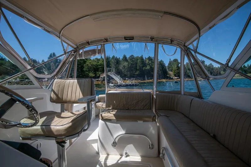 Slide: The Image of 2005 Hunt Yachts Surfhunter 29 interior with seating, steering, and scenic water view. - 10