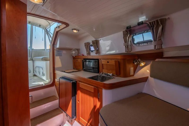 Slide: The Image of Interior of 2005 Hunt Yachts Surfhunter 29 with kitchenette and seating area. - 23