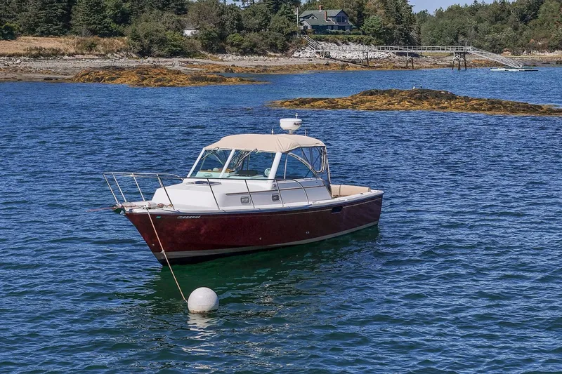 Slide: The Image of 2005 Hunt Yachts Surfhunter 29 boat anchored in scenic coastal waters. - 31