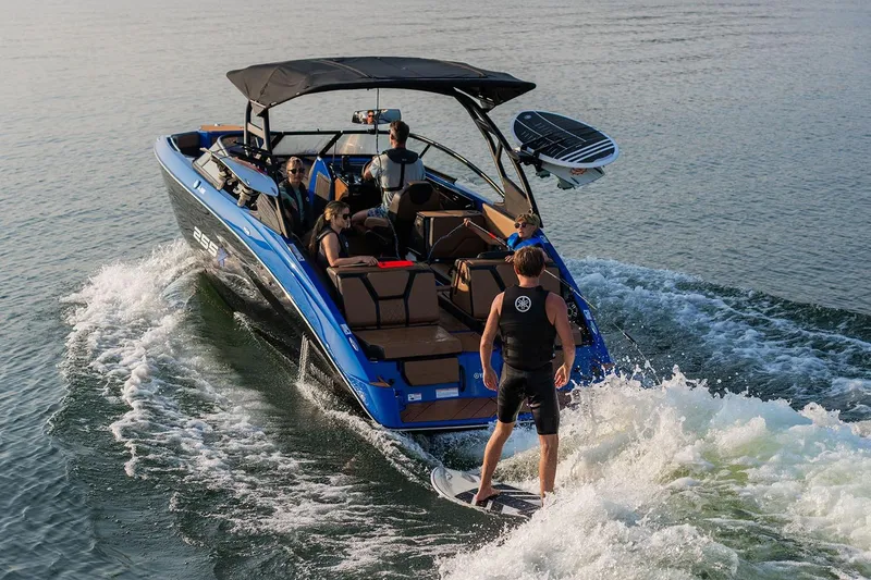Slide: The Image of Manufacturer Provided Image: 2026 Yamaha Boats 255XD with passengers and wakeboarder on a sunny day. - 2