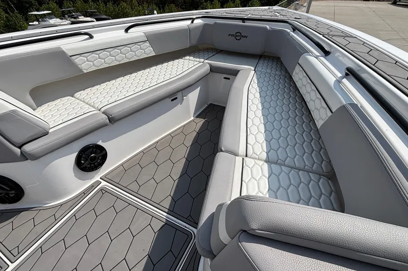 Slide: The Image of Luxurious seating area on a 2022 Fountain 38 SC boat with hexagonal pattern upholstery. - 10