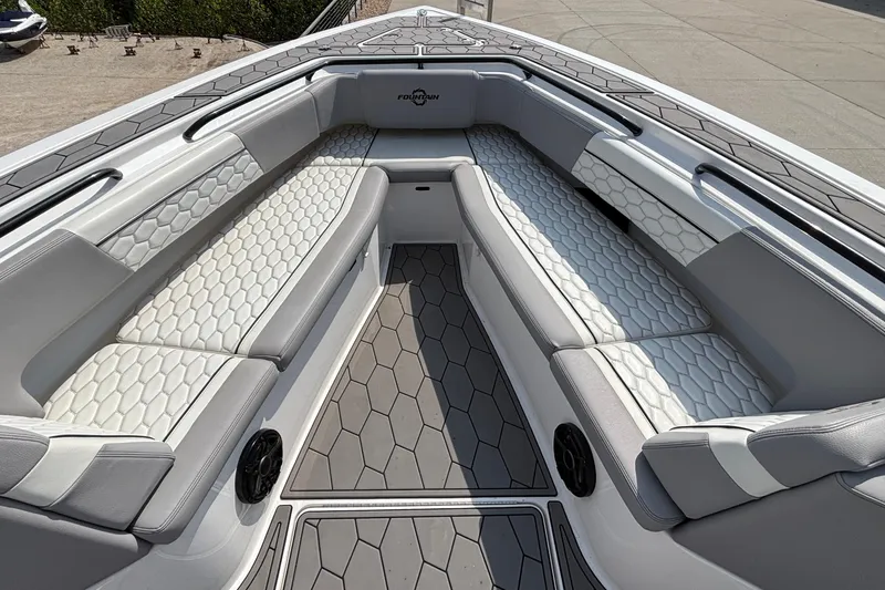 Slide: The Image of 2022 Fountain 38 SC boat interior with hexagonal-patterned seating and gray flooring. - 12
