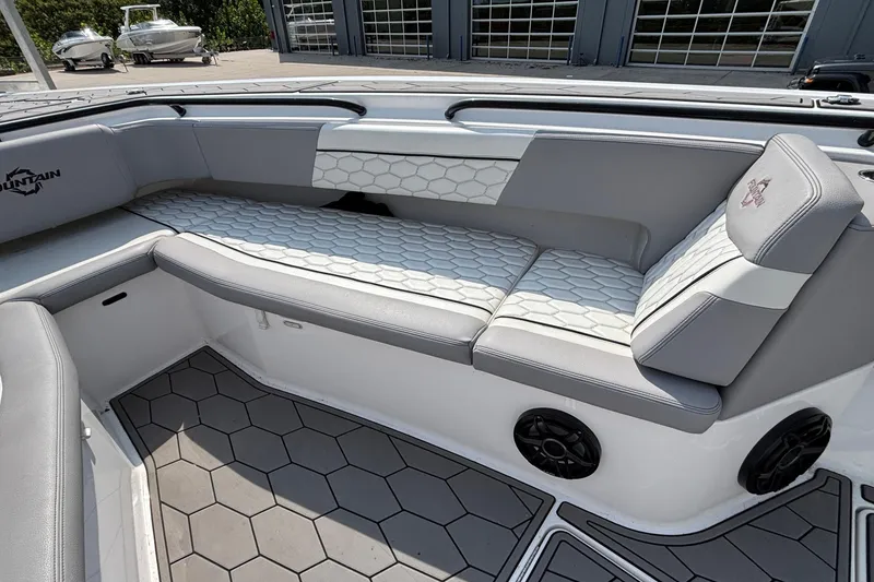 Slide: The Image of 2022 Fountain 38 SC boat interior with gray seating and hexagonal pattern flooring. - 13
