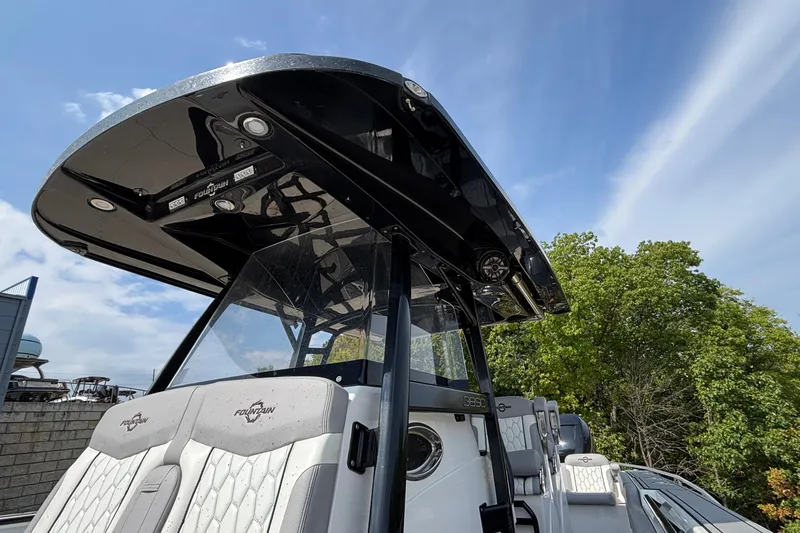 Slide: The Image of 2022 Fountain 38 SC boat with sleek design and modern features, under a clear sky. - 16