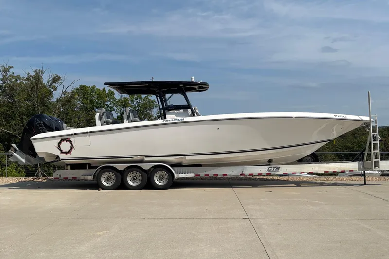 Slide: The Image of 2022 Fountain 38 SC boat on trailer, side view, outdoors. - 3