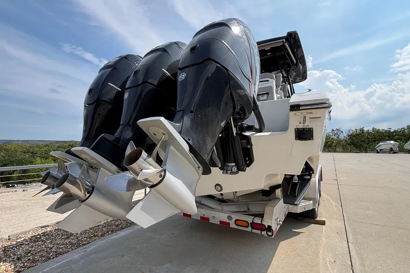 Slide: The Image of 2022 Fountain 38 SC boat with triple outboard engines on a trailer. - 5