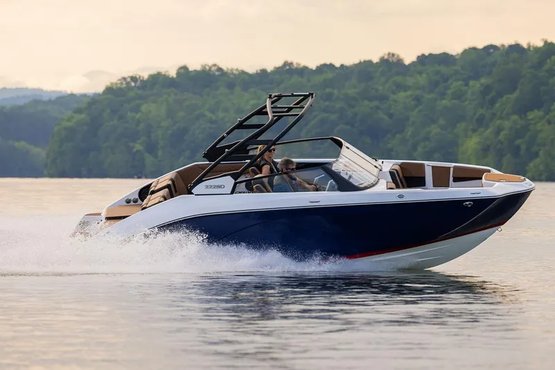 Slide: The Image of Manufacturer Provided Image: 2026 Yamaha Boats 222SD cruising on a serene lake with lush green forest backdrop. - 1