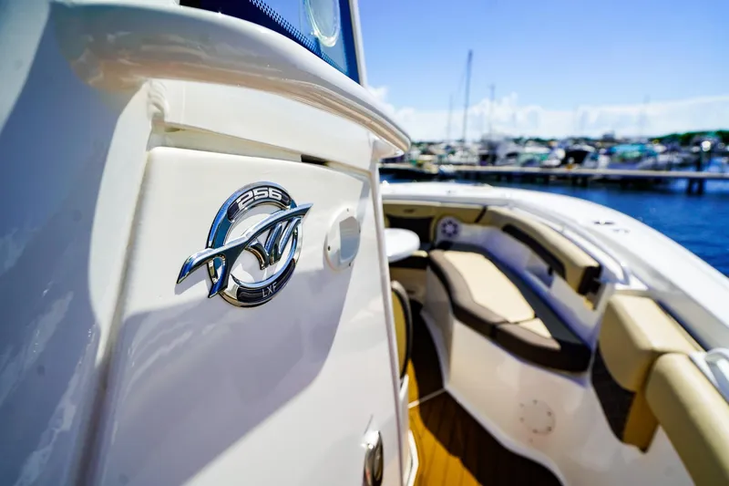 Slide: The Image of 2021 Tidewater 256 LXF boat docked, showcasing sleek design and comfortable seating. - 15