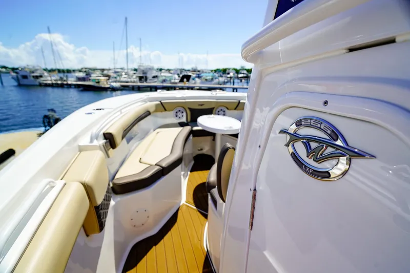 Slide: The Image of 2021 Tidewater 256 LXF boat interior with seating, docked at marina. - 19