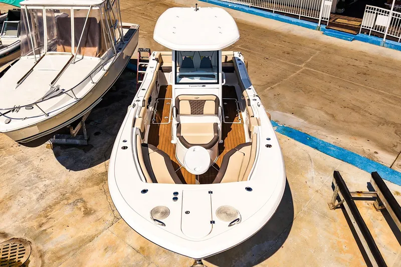 Slide: The Image of 2021 Tidewater 256 LXF boat on dry dock, top view, showcasing spacious deck layout. - 32