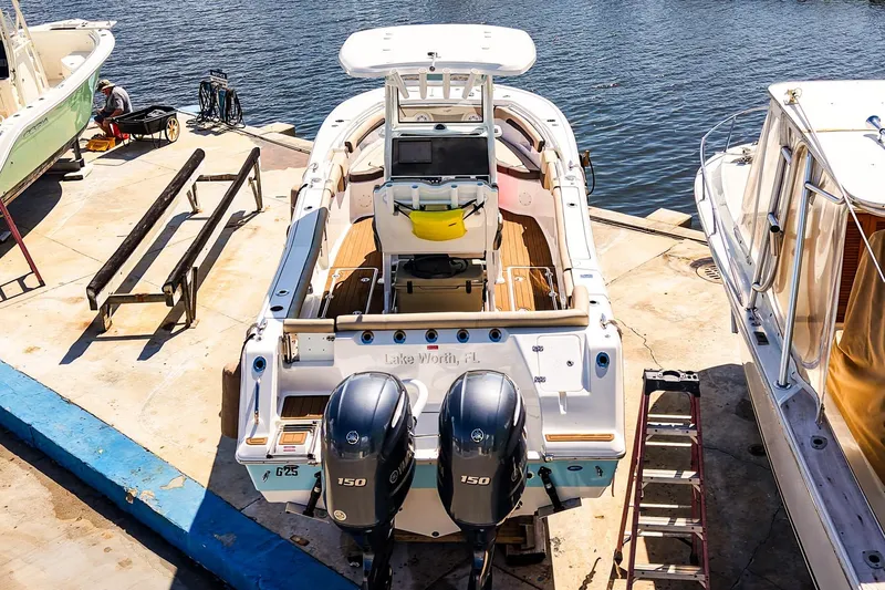 Slide: The Image of 2021 Tidewater 256 LXF boat docked with dual engines, viewed from above. - 33