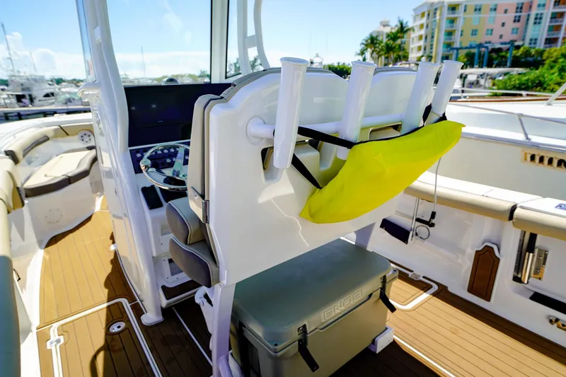 Slide: The Image of 2021 Tidewater 256 LXF boat interior with helm, rod holders, and seating. - 7