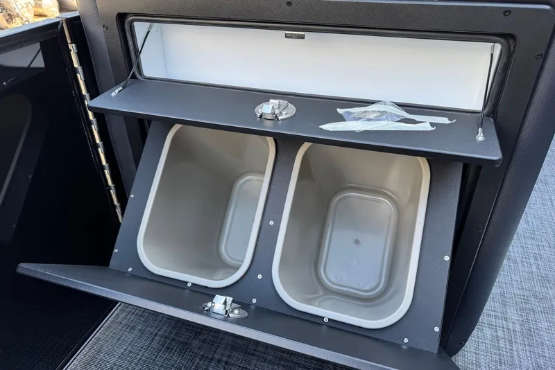 Slide: The Image of 2026 Godfrey SWEETWATER 2286 SFL storage compartment with dual bins and secure latch. - 17