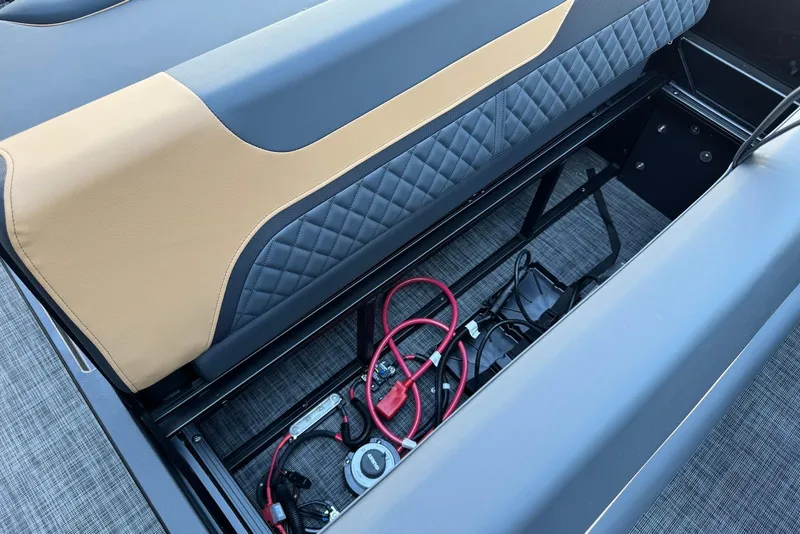 Slide: The Image of Storage compartment of 2026 Godfrey SWEETWATER 2286 SFL boat with cables and quilted upholstery. - 28