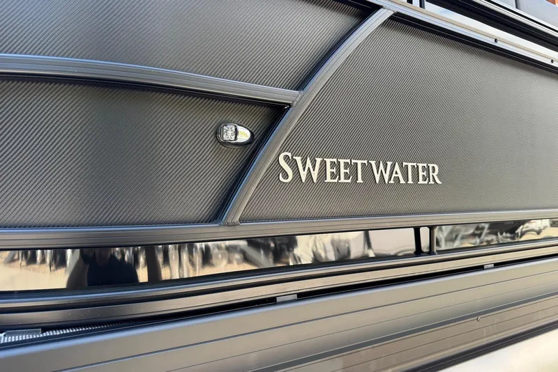 Slide: The Image of 2026 Godfrey SWEETWATER 2286 SFL boat with sleek black exterior design. - 40