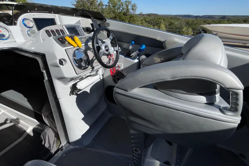 Slide: The Image of Interior of 2013 Sunsation 36 XRT boat, featuring sleek dashboard and comfortable seating. - 22