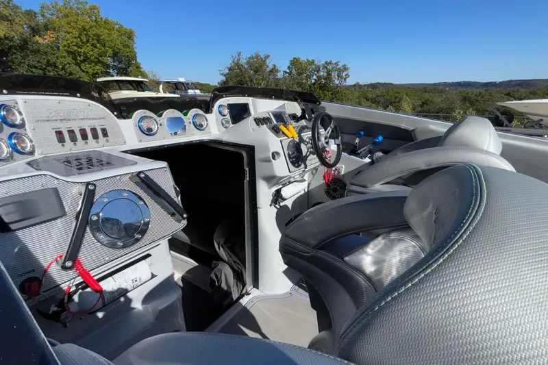 Slide: The Image of 2013 Sunsation 36 XRT boat interior with sleek dashboard and comfortable seating. - 29