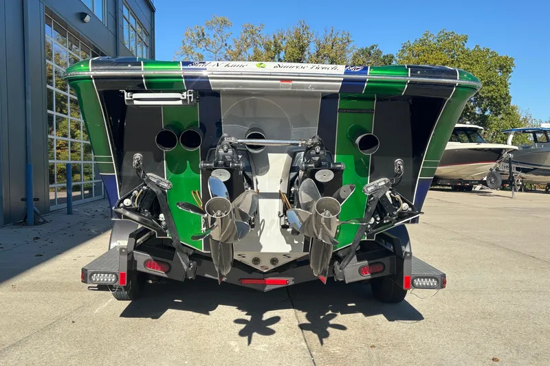Slide: The Image of Rear view of 2013 Sunsation 36 XRT boat with dual propellers and vibrant green accents. - 3