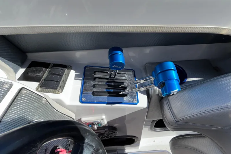 Slide: The Image of 2013 Sunsation 36 XRT boat cockpit with blue throttle controls and carbon fiber accents. - 32