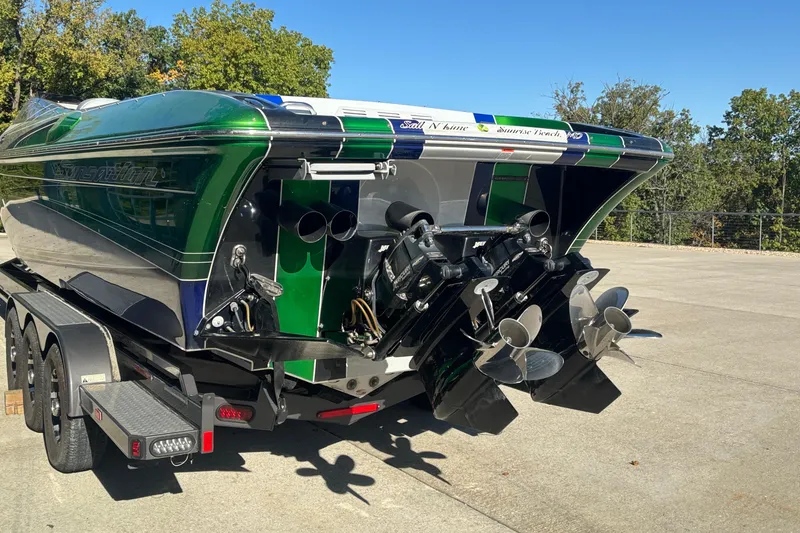 Slide: The Image of 2013 Sunsation 36 XRT powerboat on trailer, featuring dual propellers and vibrant green accents. - 4