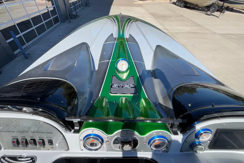 Slide: The Image of 2013 Sunsation 36 XRT boat dashboard with sleek design and vibrant green accents. - 41