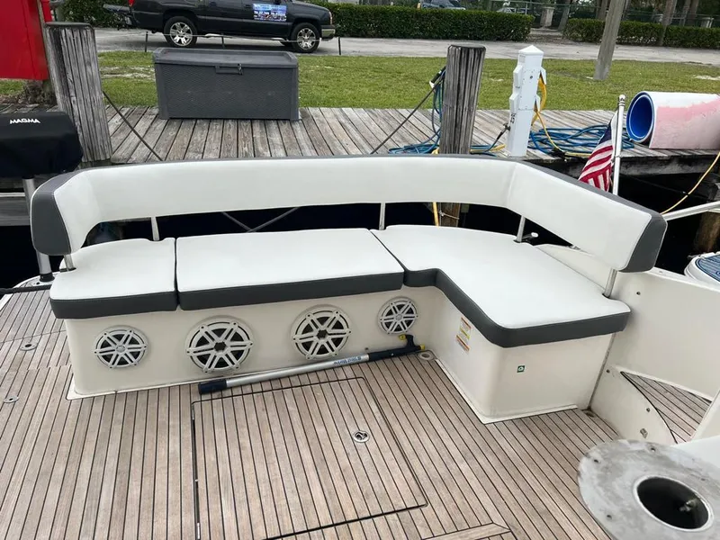 Slide: The Image of Bavaria Sport 360 HT 2016 boat with white cushioned seating and speakers on deck. - 12